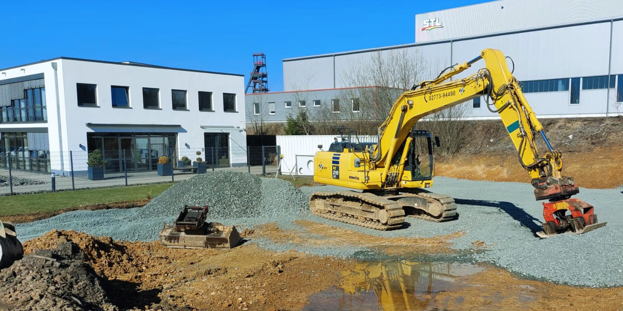 Excavator levels the ground for the construction of the Packaging Innovation Center on the Kalteiche site in Haiger, Germany